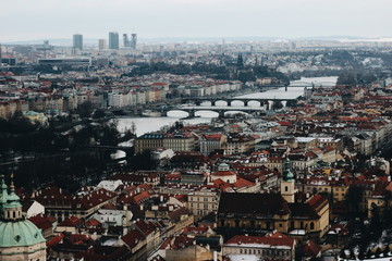 Obraz premium Panorama of the city of Prague with houses and a bridge across the river. Nice view on the postcard.