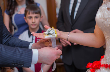 The man puts the wedding bag on the girl's hand and puts money between them. Wedding from Azerbaijan