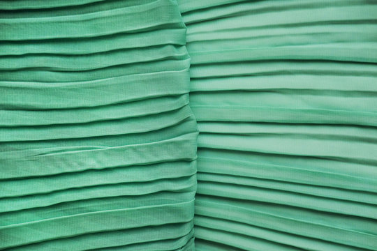 Green georgette fabrics. The texture of the mint pleated fabric.