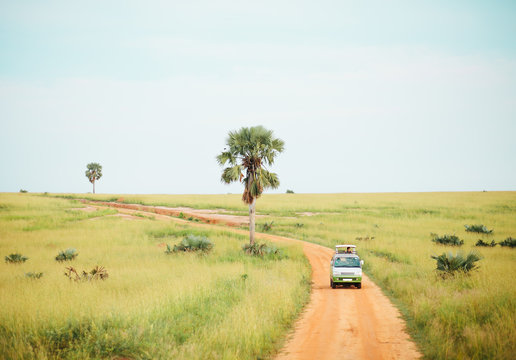 Safari Vehicle Cruising Through African Landscapes