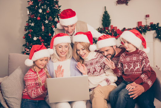 Hey! Modern networking, communication, online web wireless telecommunication, roaming connection, chat convrsation, distance. Six relatives in x mas costumes, at home, wave with hand palms