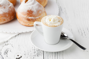 Breakfast with cappuccino and croissant