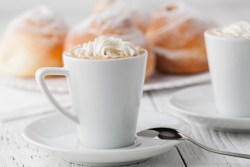 cup of black coffee and sweet bun for breakfast, close-up