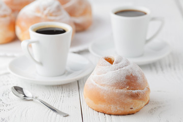 cup of black coffee and sweet bun for breakfast, close-up