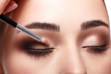 Naklejka premium Applying female makeup, isolated on white