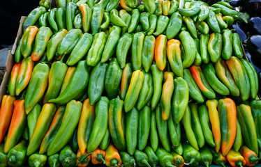 Green peppers in stack in a vegetables stand in a street market in Madrid, Spain.