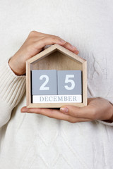 December 25 in the calendar. the girl is holding a wooden calendar. Boxing Day, St. Stephen's Day