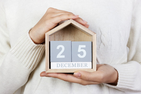 December 25 in the calendar. the girl is holding a wooden calendar. Boxing Day, St. Stephen's Day - Powered by Adobe
