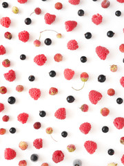 Fresh berries pattern. Composition of raspberry, currant and strawberry on a white background. Top view, flat lay. Food background. Food wallpaper.