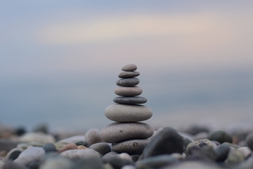 a pyramid of stones by the sea