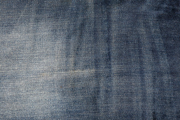 Fragment of wrinkled blue jeans fabric, abstract texture