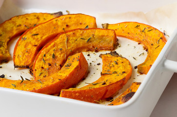 Pieces of pumpkin on a tray, baked in the oven.