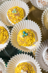 Yellow and white cakes in white cups on a glass stand