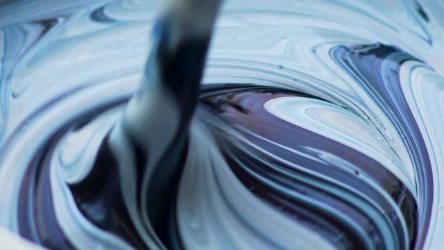 Experienced artist stirring colors, working on piece of art, inspiration