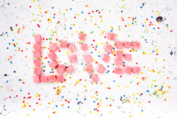 word love of sweets on white background. top view.