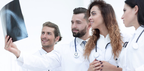 Fototapeta premium Portrait of young male doctors looking at x-ray