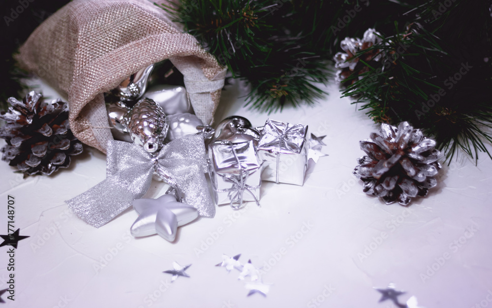 Wall mural Beautiful silver Christmas decorations spilling out of a hessian sack