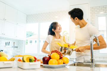 Asian teen couple are helping to make dinner. And bakery together happily. On Valentine's Day in their home.