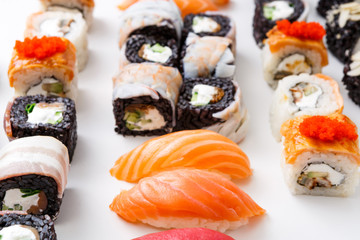 Closeup set of sushi rolls, maki with caviar on white background