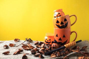 halloween cup mug with dry flower on yellow ground
