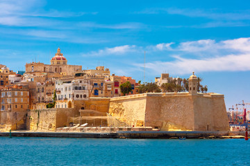 Quay of Valletta with traditional Maltese building with colorful shutters and balconies in the sunny day, Valletta, Capital city of Malta