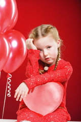 Valentine's Day girl in red dress with a red heart.