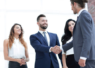 handshake business partners at a meeting