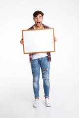 Fototapeta premium Full length portrait of an amused cheerful guy