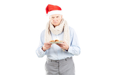 Portrait of senior man in Santa hat on white background