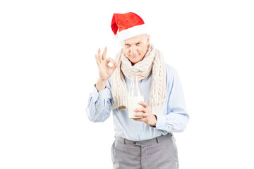 Fototapeta na wymiar Portrait of senior man in Santa hat on white background