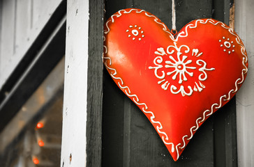 Christmas heart on old wooden house. Toned photo.