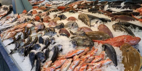Fotobehang Variety of sea fishes on the counter in a greek fish shop. © vikakurylo81