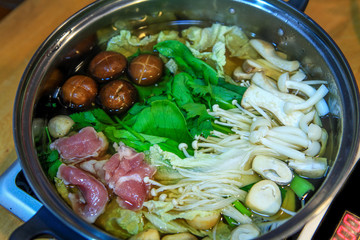 Mix vegetable with meat soup in pot (Shabu or similar with Sukiyaki)
