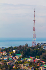 Aerial view of buildings an TV tower on the background of the sea in sunny day, Sochi, Russia