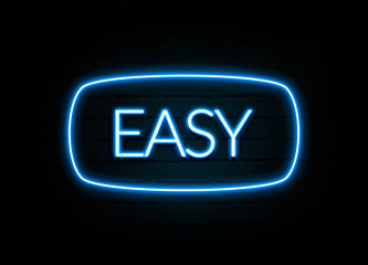 Easy  - colorful Neon Sign on brickwall