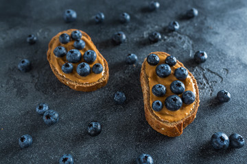 Snack with bread, peanut butter and berries. Healthy food concept.