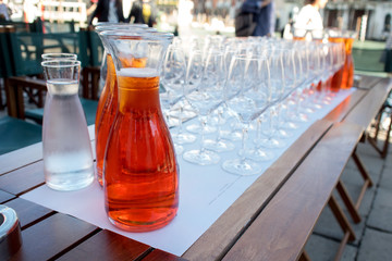Aperol cocktail in a bottle at restaurant on the street