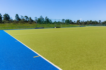 Obraz premium Hockey Goals Field Astro Turf Blue Sky