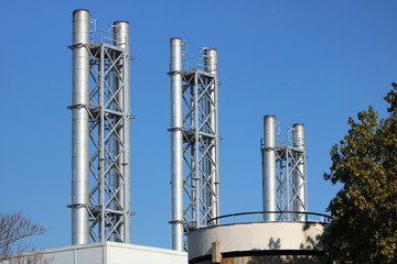 smokestacks with blue sky background