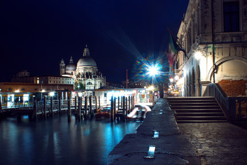 Night view Cathedral of Santa Maria della Salute and gondola in the foreground in Venice, Italy