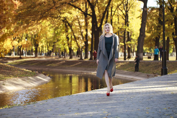 Portrait of a young beautiful woman in gray coat