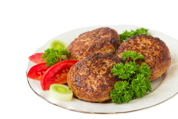 Homemade cutlets with a tomatoes, parsley  on a plate. White background.