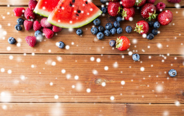 close up of fruits and berries on wooden table