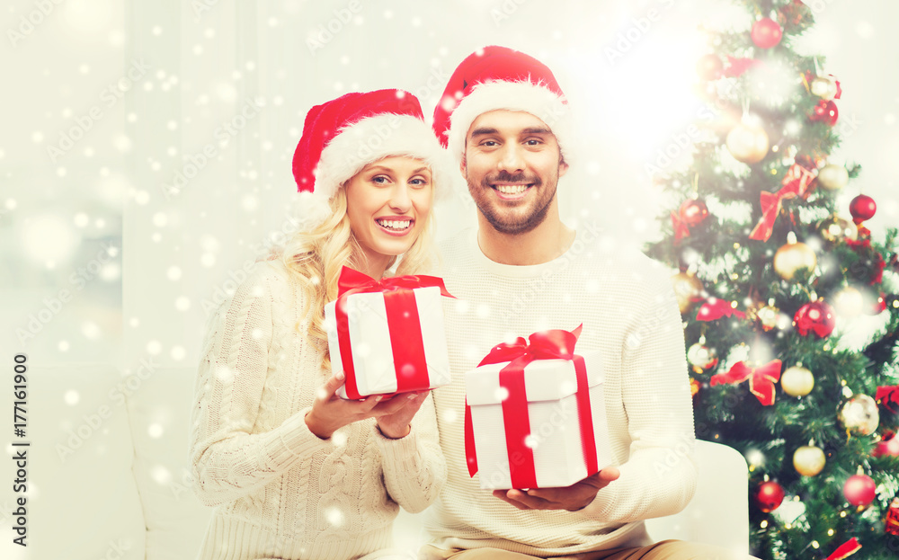 Poster happy couple at home with christmas gift boxes