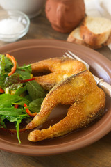 Fish fried in corn flour, served with salad, bread and wine.