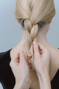 Woman braiding hair