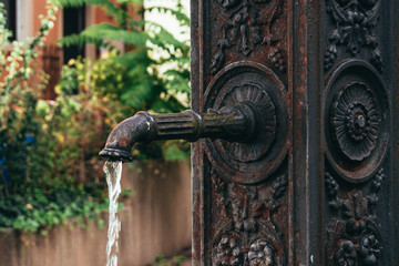 Real vintage old public water tap with pattern