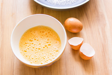 Fresh eggs in a cup and egg shell, pan