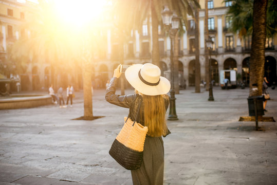 Young woman tourist walking on the reila square in Barcelona city