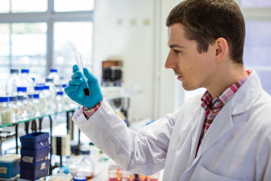 Lab Worker Mixing Liquid in a Test Tube